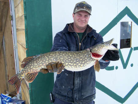 Pictured here is fishing Guide Jeffery Peete of Champlain Valley Traditions with a fantastic Northern Pike. This fish was caught on March 3, 2007 while ice fishing with tip-ups on Lake Champlain