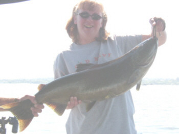 Jennifer Conley and some friends were fishing from a private boat in the Oswego Harbor. Thats when Jennifer caught her first king salmon. This fine specimen weighed in at 20 pounds. It was caught on a home made tinsel fly behind a spin doctor flasher