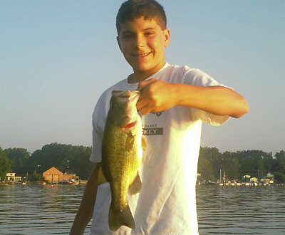 Shayne McGowan age 13, was fishing with his father in Sodus Bay when he caught this 14 inch largemouth bass