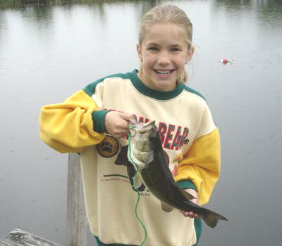 Michelle Woychak was fishing in the family pond behind the house when she caught this 3 and half pound Largemouth Bass