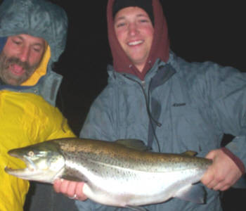 Nathan Siegal proudly displays a monster brown trout that they caught & released while night fishing